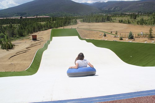 all-season turf with back of person tubing down the hill